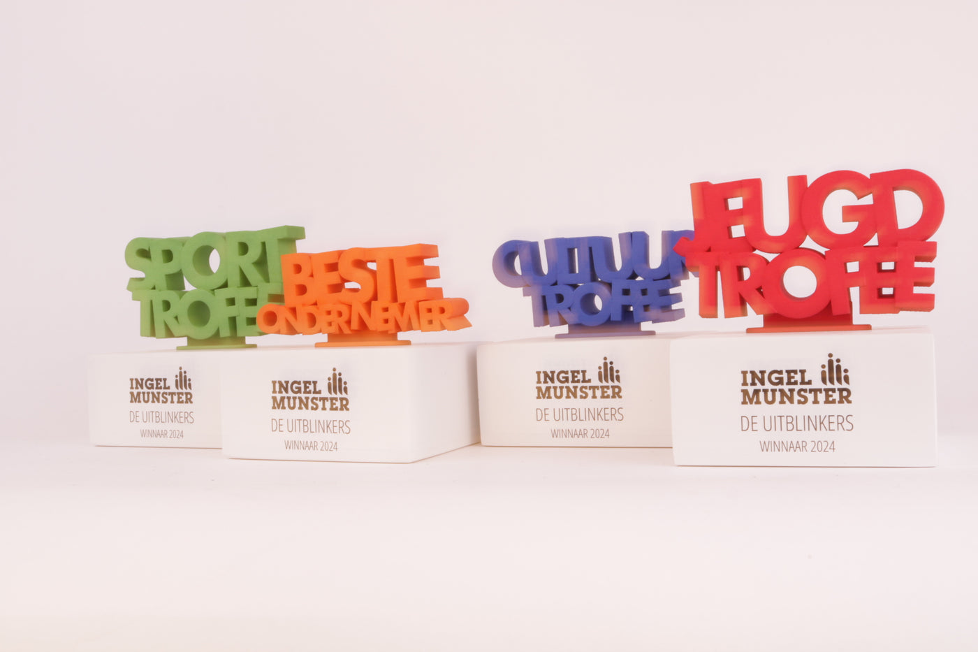 white trophy stand with colorfull 3d printed trophies