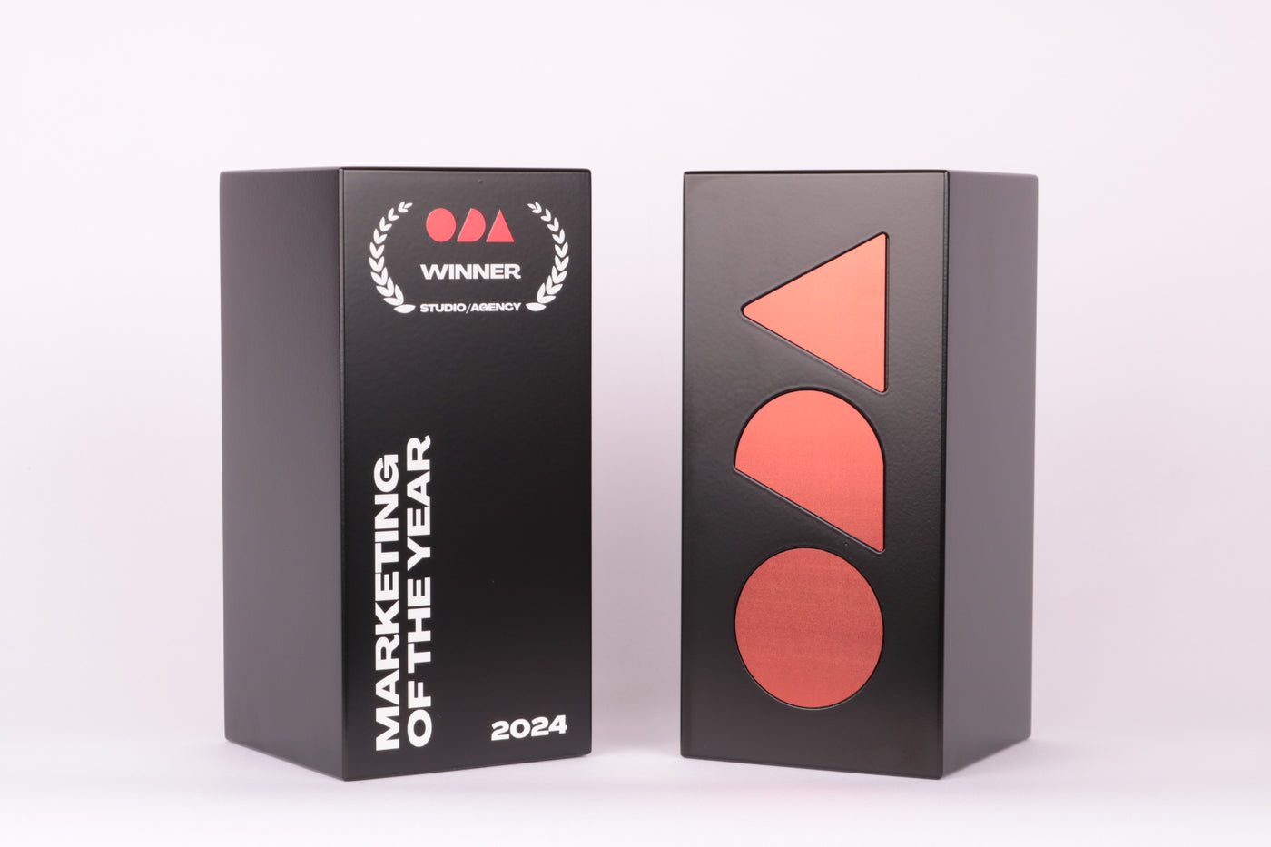 black and red colored trophies for the marketing of the year (2024)
