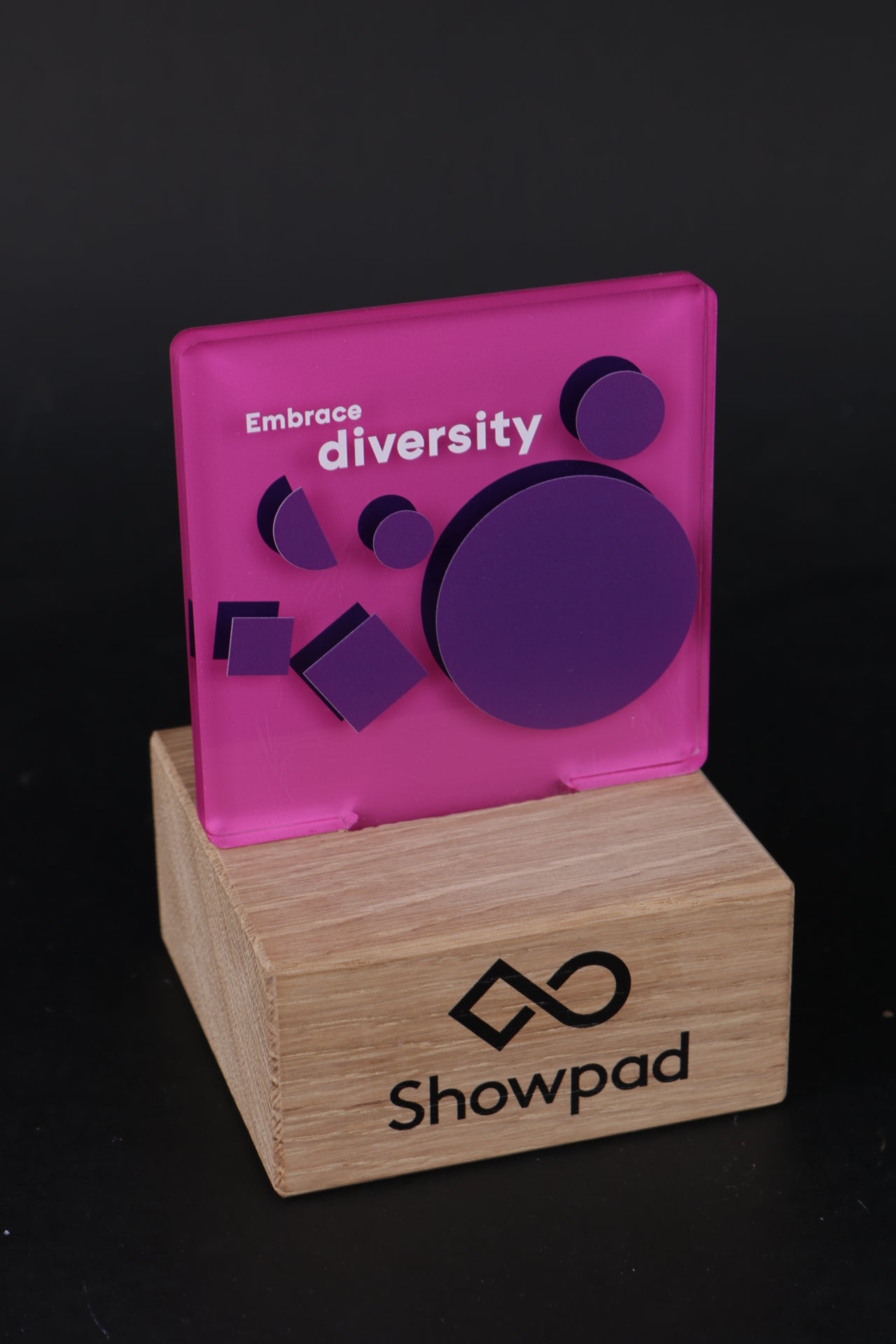 wooden trophy stand with a pink acrylic logo design