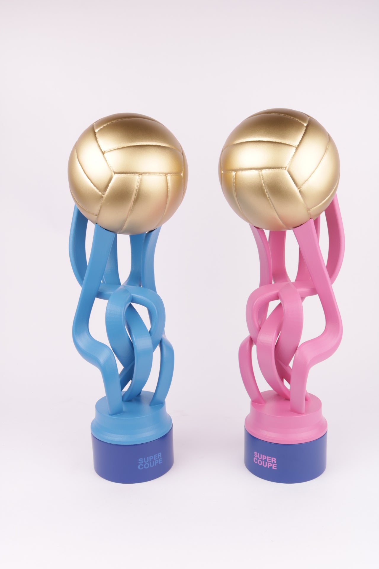 blue base with a blue or pink 3d printed trophy and a golden ball on top